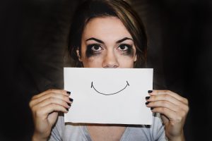 Image of a crying woman covering her mouth with a drawing of a smile. Don’t deal with depression symptoms alone. Meet online with a psychiatrist and start depression medication in Indiana. 26375 Schererville | 46615 South Bend | 46515 Elkhart